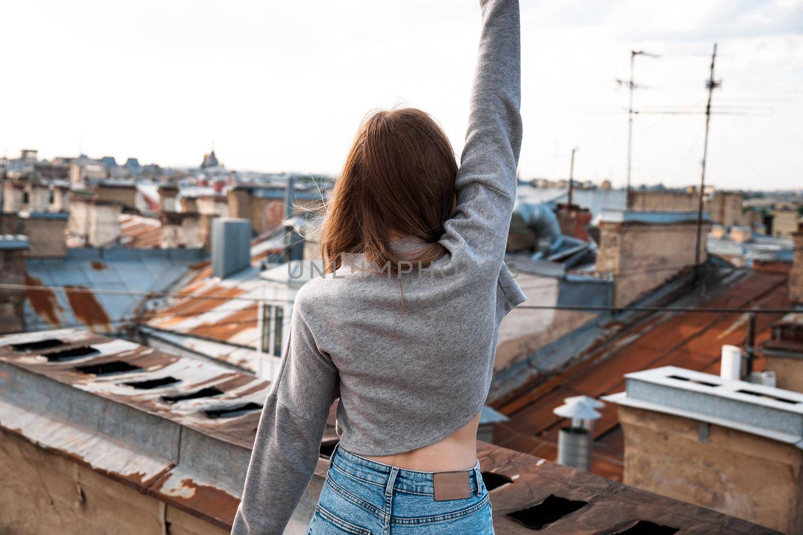 Woman is happy on the roof of Saint Petersburg, Russia by natali_brill