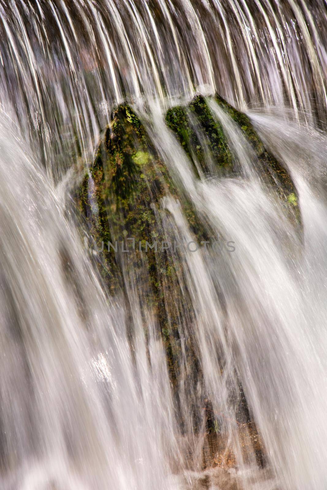 Beautiful veil cascading waterfalls, mossy rocks. close up picture