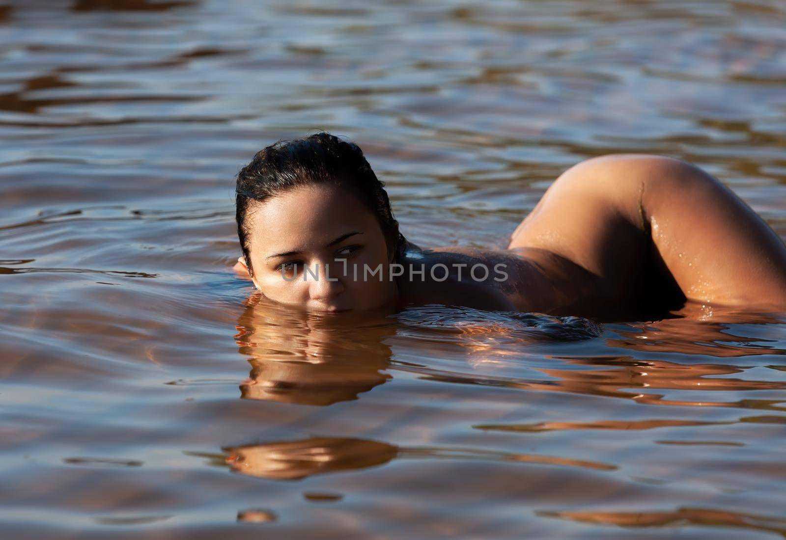 Young nude woman on the sea coast by palinchak