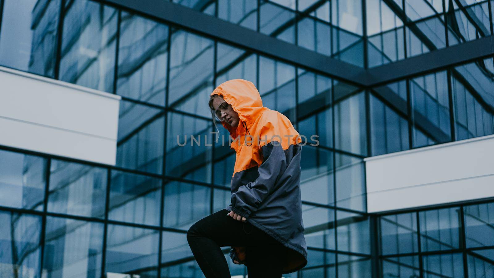 Girl in orange protective overalls and glasses. Air pollution and hazard concept