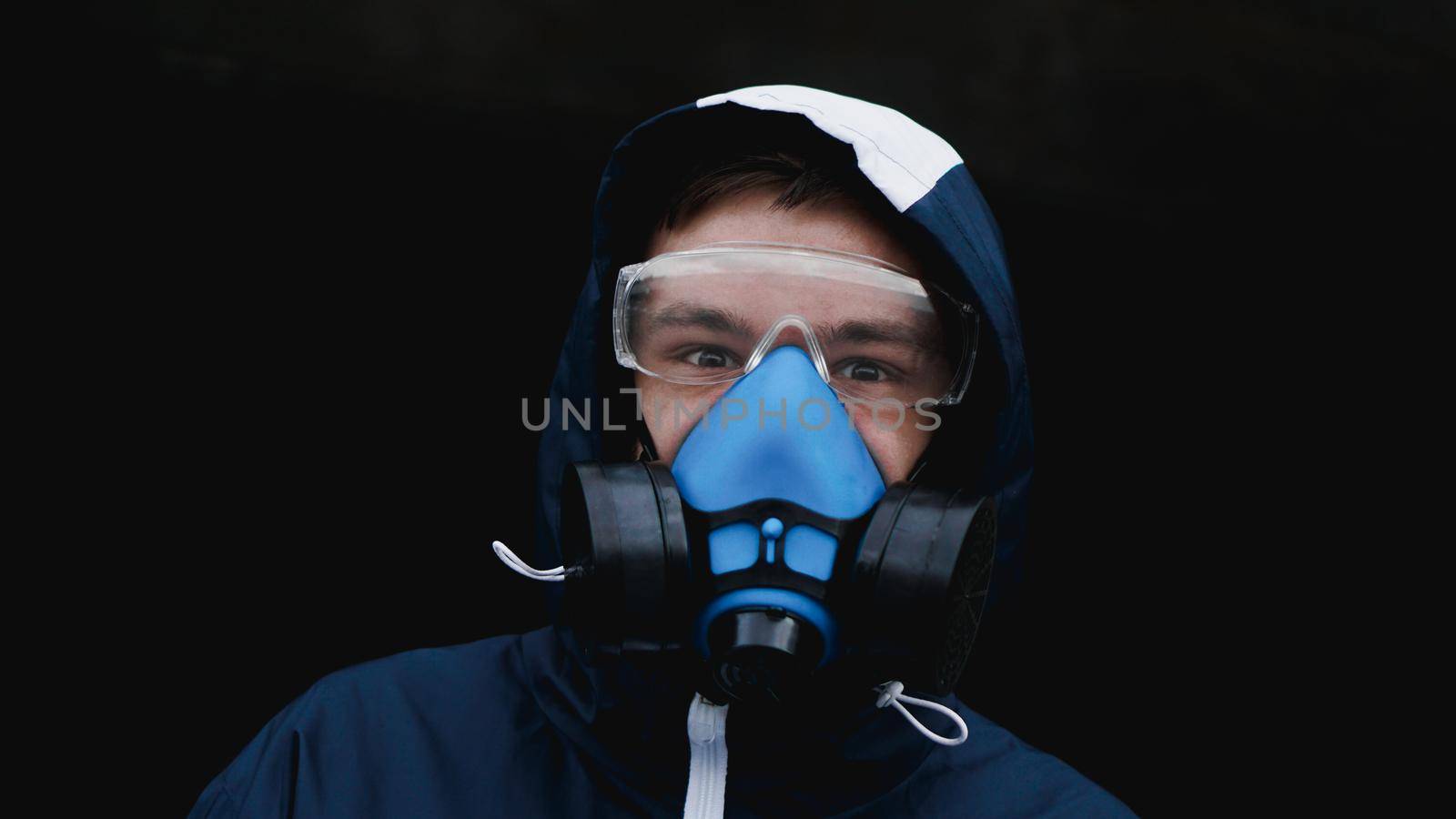 Protection respirator half mask for toxic gas.The man prepare to wear protection air pollution in the chemical industry