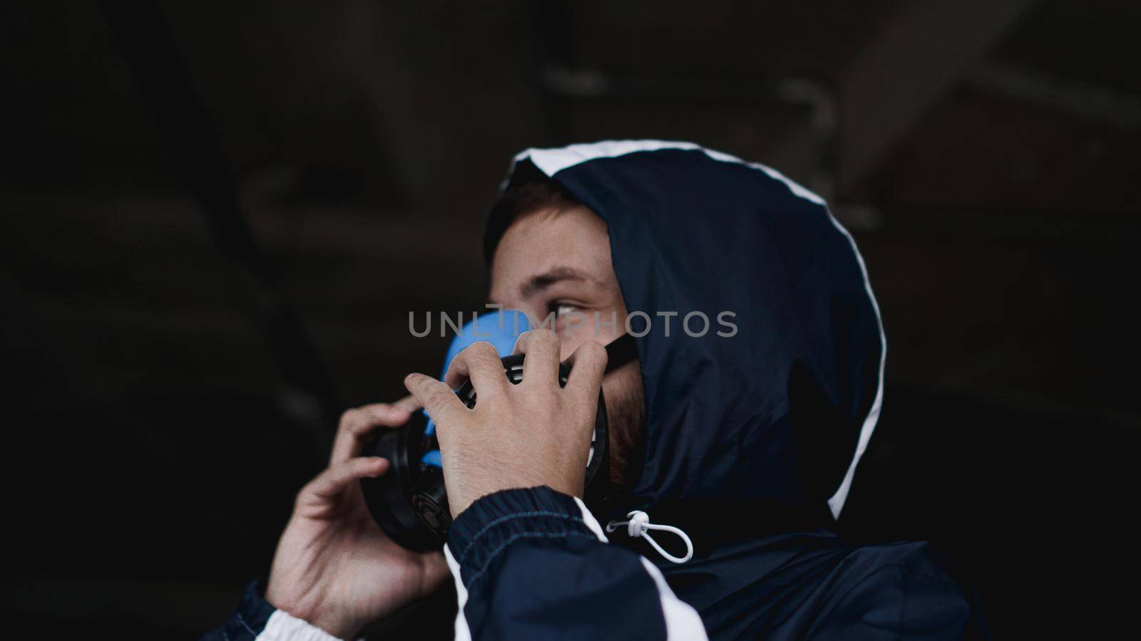 Protection respirator half mask for toxic gas.The man prepare to wear protection air pollution. A man puts on a mask. Selective focus