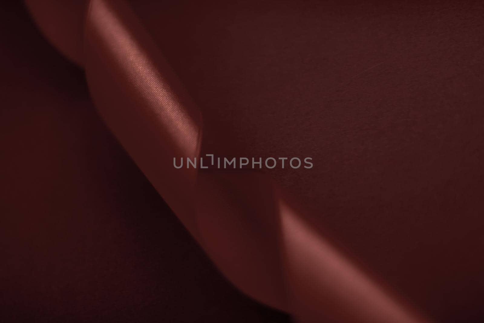 Branding, holidays and luxe brands concept - Abstract silk ribbon on chocolate background, exclusive luxury brand design for holiday sale product promotion and glamour art invitation card backdrop
