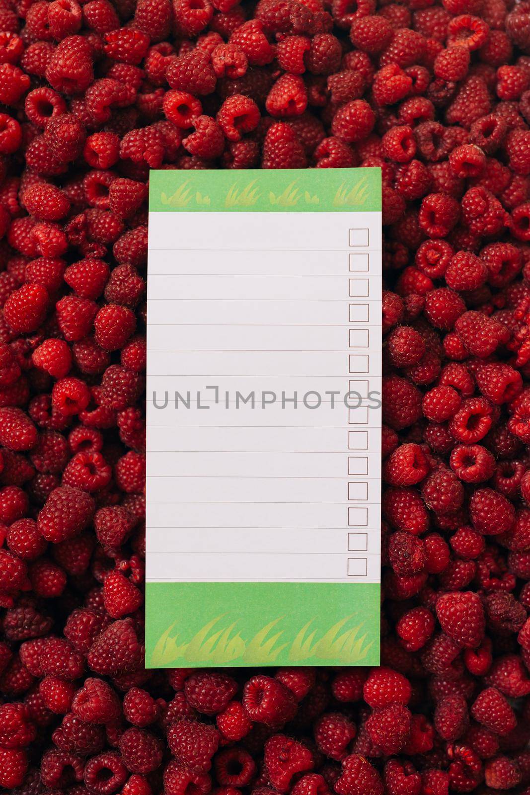 Empty sheet to insert dough, against the background of the texture of raspberries. High quality photo