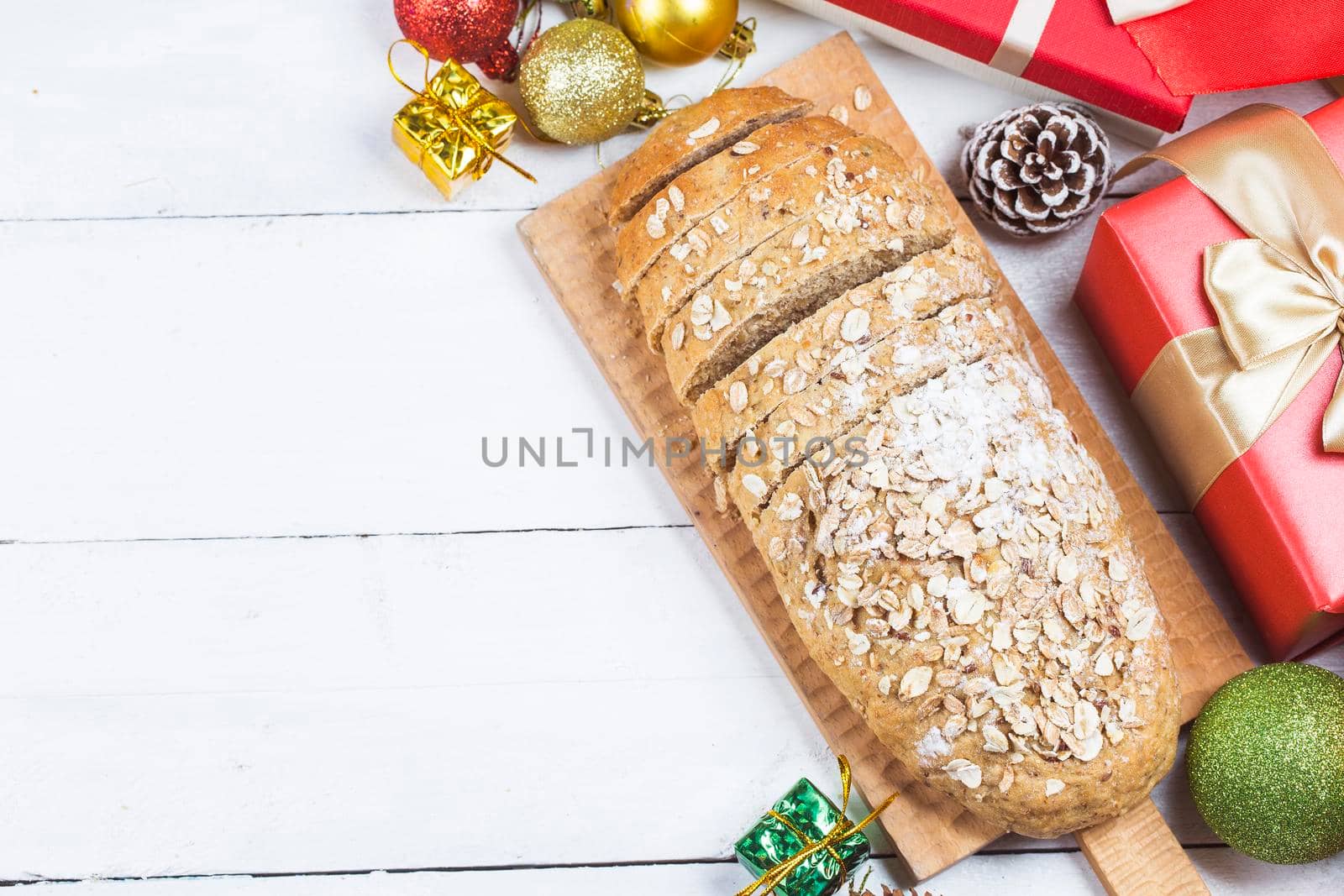 Top view of sliced wholegrain bread on a wooden cutting board.