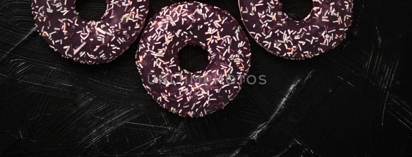 Bakery, branding and cafe concept - Frosted sprinkled donuts, sweet pastry dessert on rustic wooden background, doughnuts as tasty snack, top view food brand flat lay for blog, menu or cookbook design