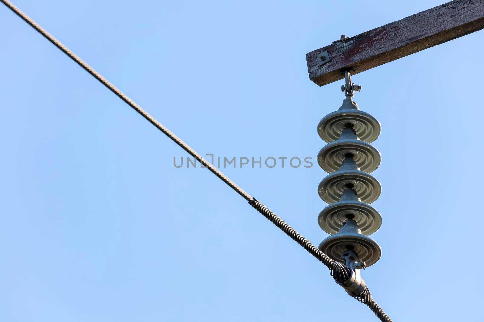 Photograph of a transmission line cable system connected to an assembly bracket