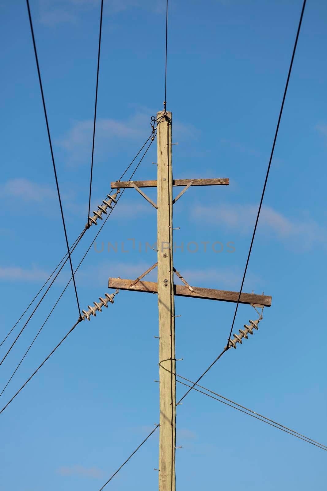Photograph of a wooden telephone post and cables by WittkePhotos