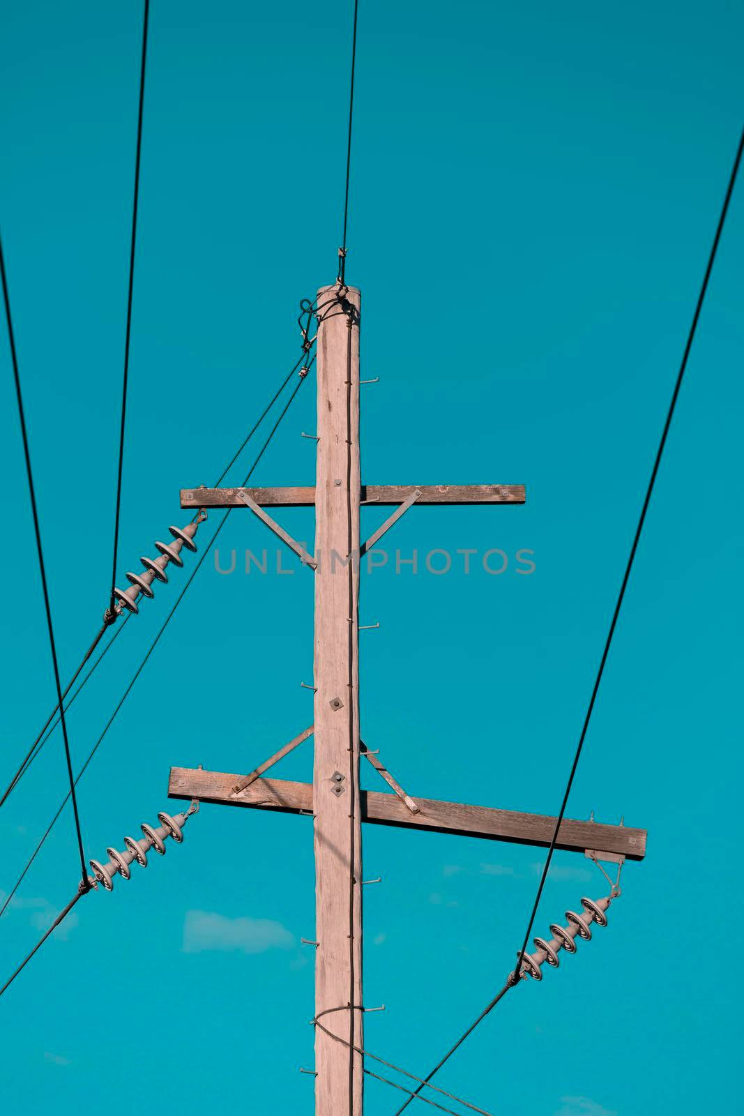 Photograph of a wooden telephone post and cables by WittkePhotos