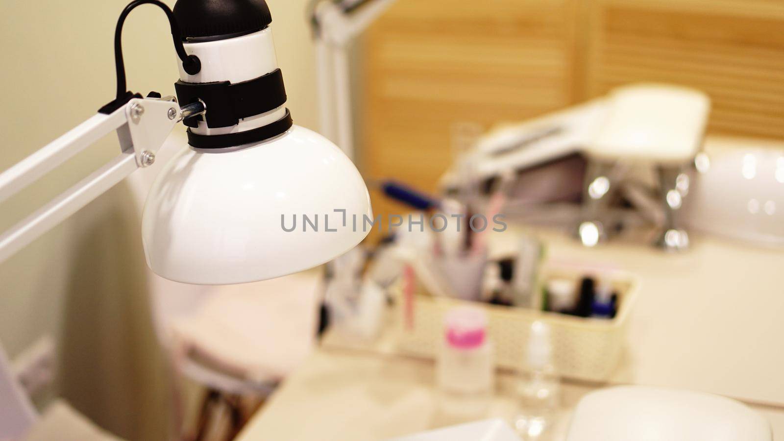 Lamp on a blurry background of nail salon. Website banner with place for text