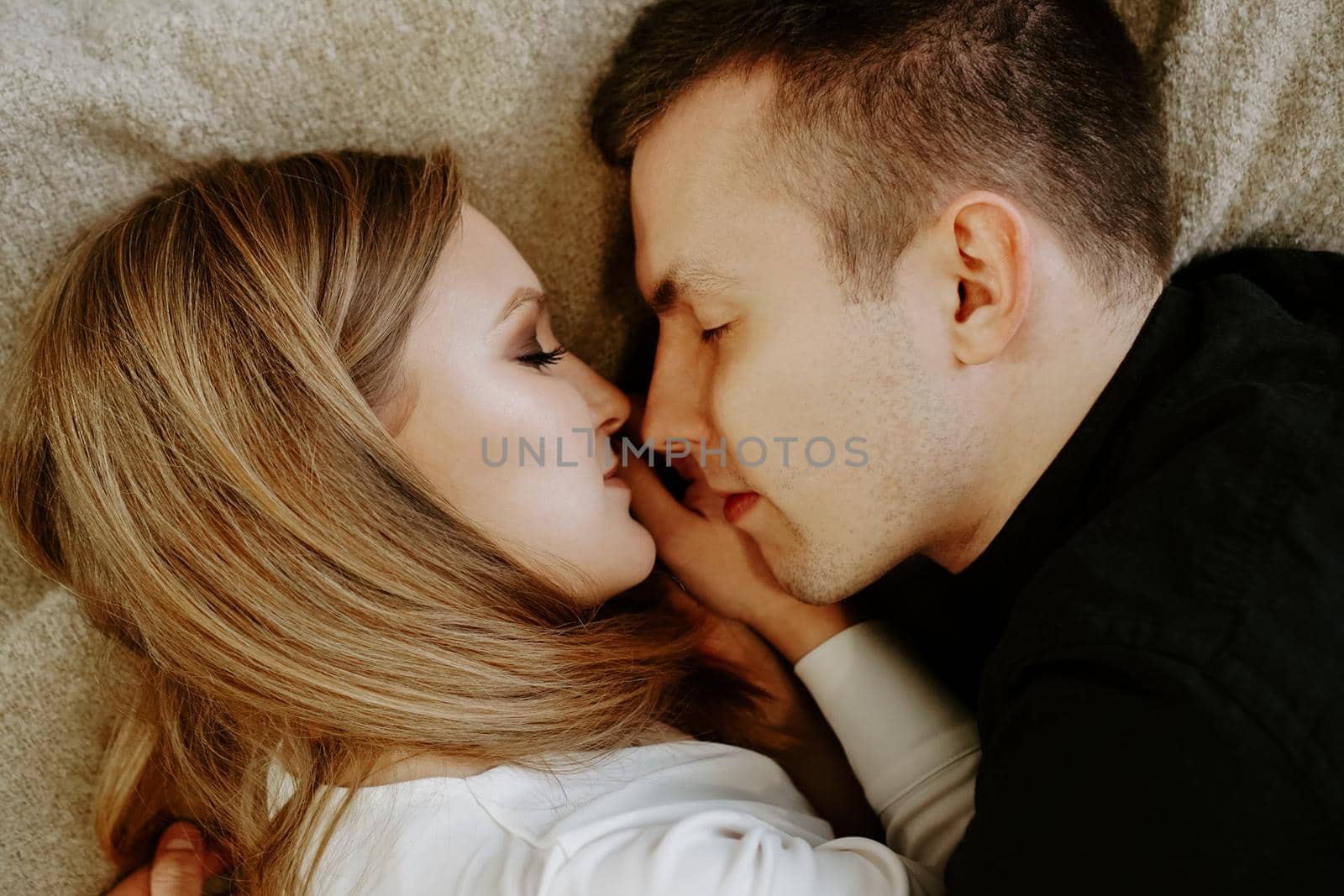 Close-up portrait of a young couple in bed at home by natali_brill