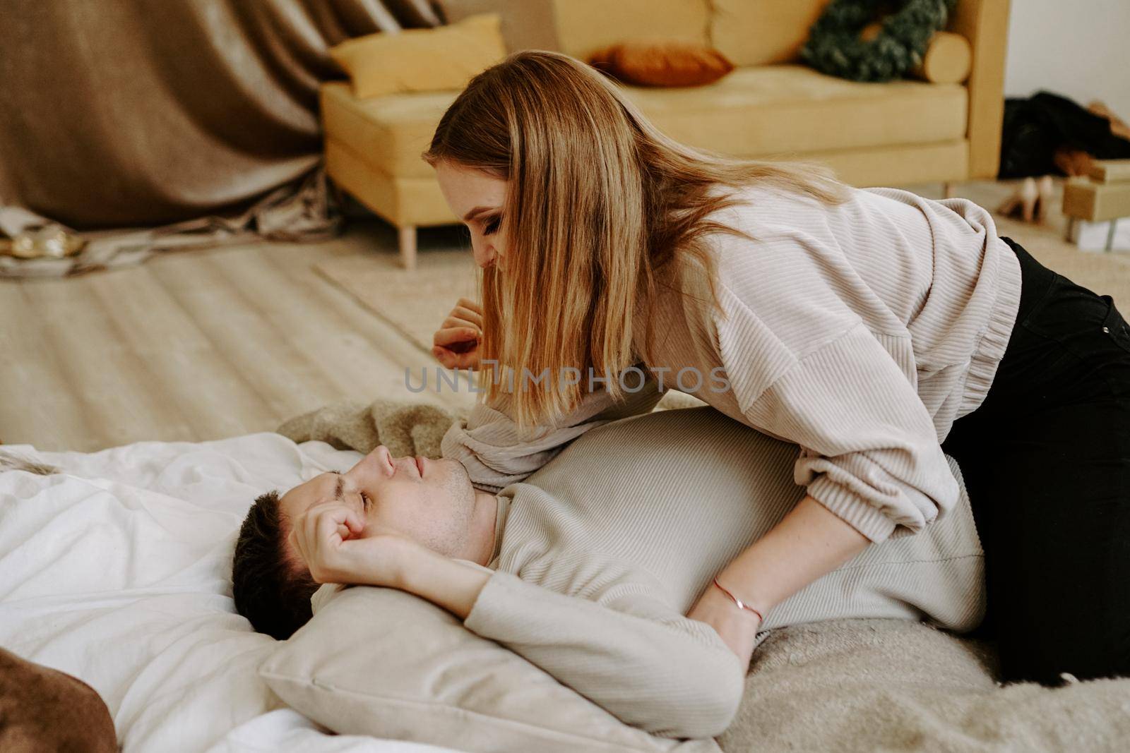 Business couple on bed in hotel room - tender hugs