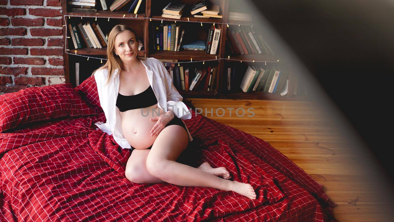 Beautiful young stylish pregnant woman in black lingerie and white shirt, loft by natali_brill