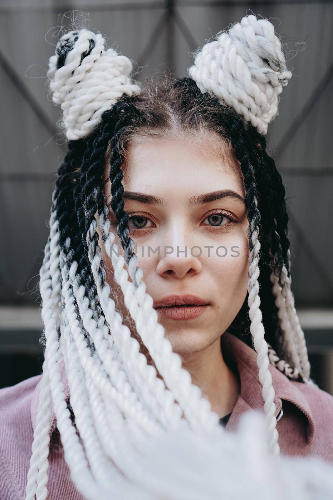 Young woman with futuristic looks. Girl with black and white pigtails by natali_brill