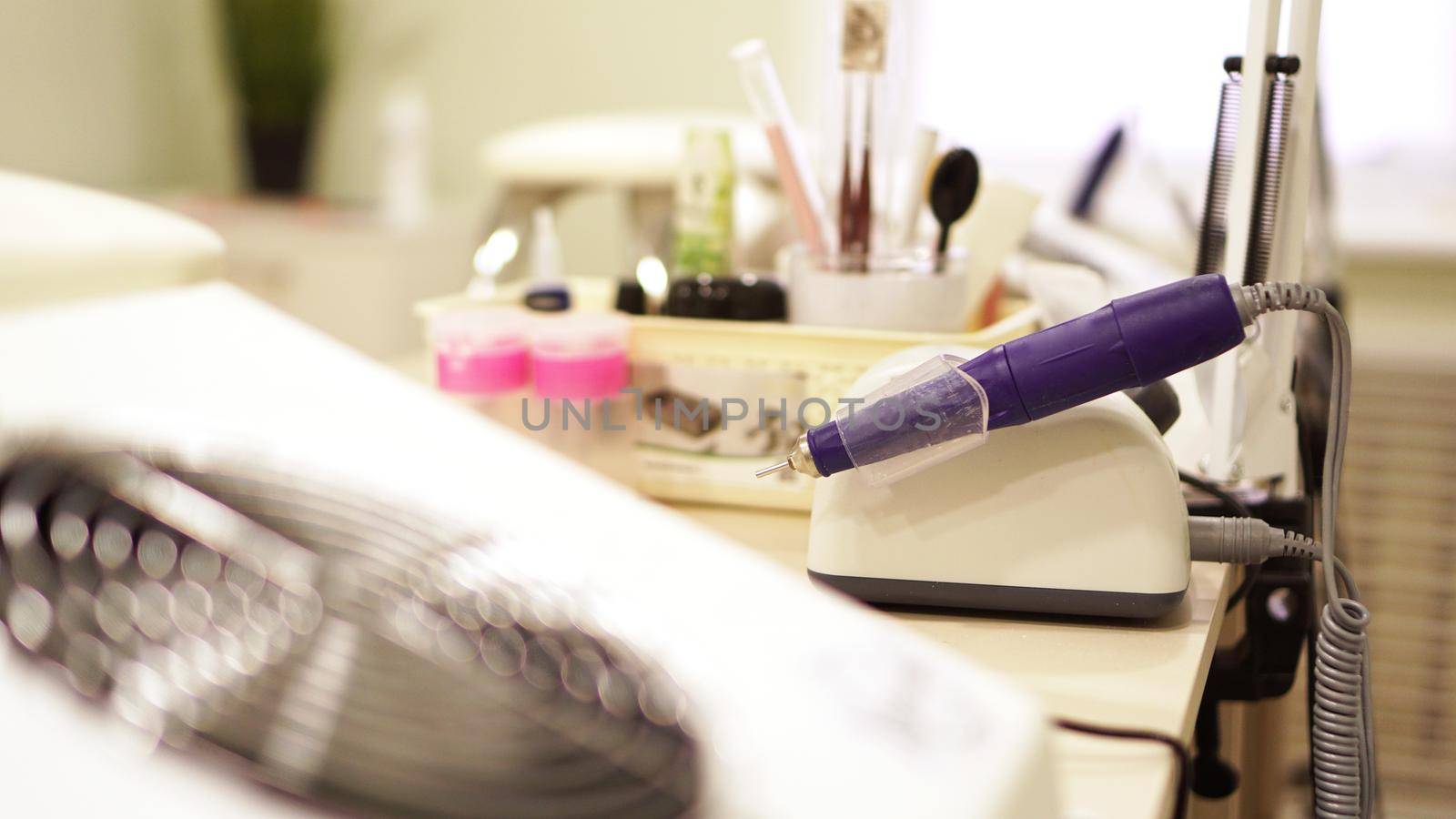 Professional equipment on a blurry background of nail salon. Website banner with place for text