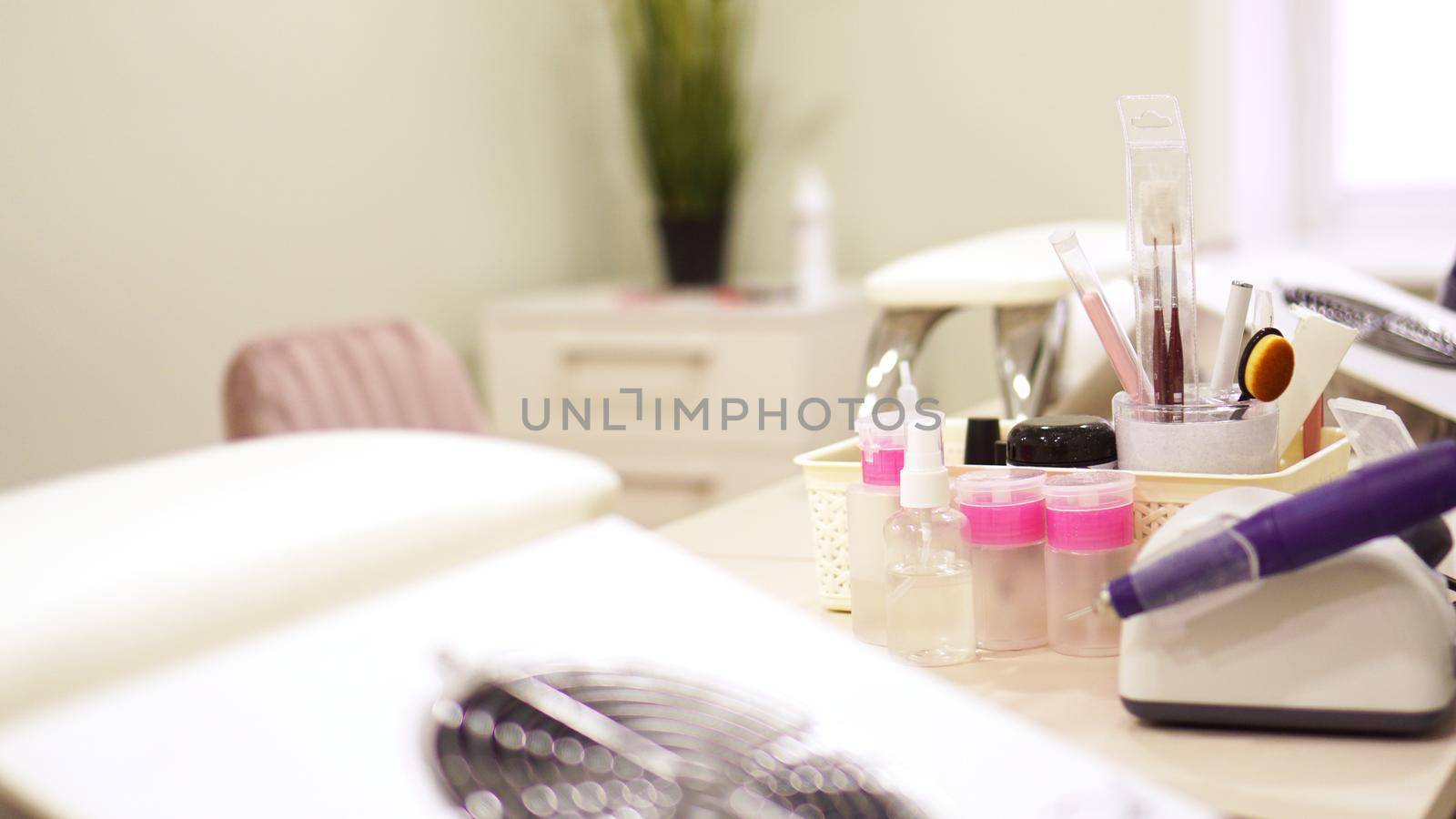 Professional equipment on the background of a blurry nail salon. by natali_brill