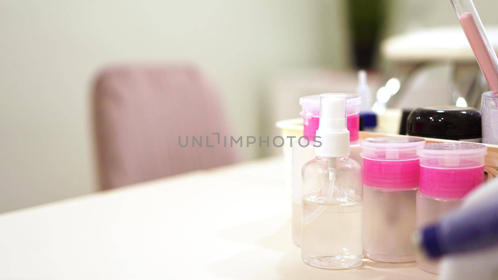 Equipment - plastic jars with solutions and water in nail salon by natali_brill