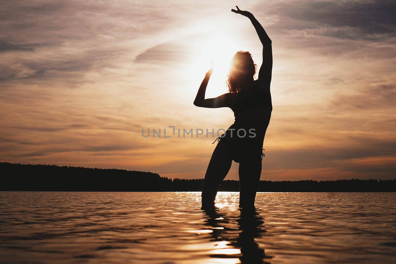 Happy Carefree Woman Enjoying Beautiful Sunset on the Beach - Summer photo