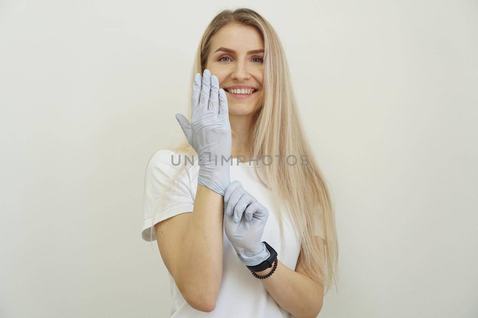 Young energetic beautiful girl puts on gloves. by natali_brill