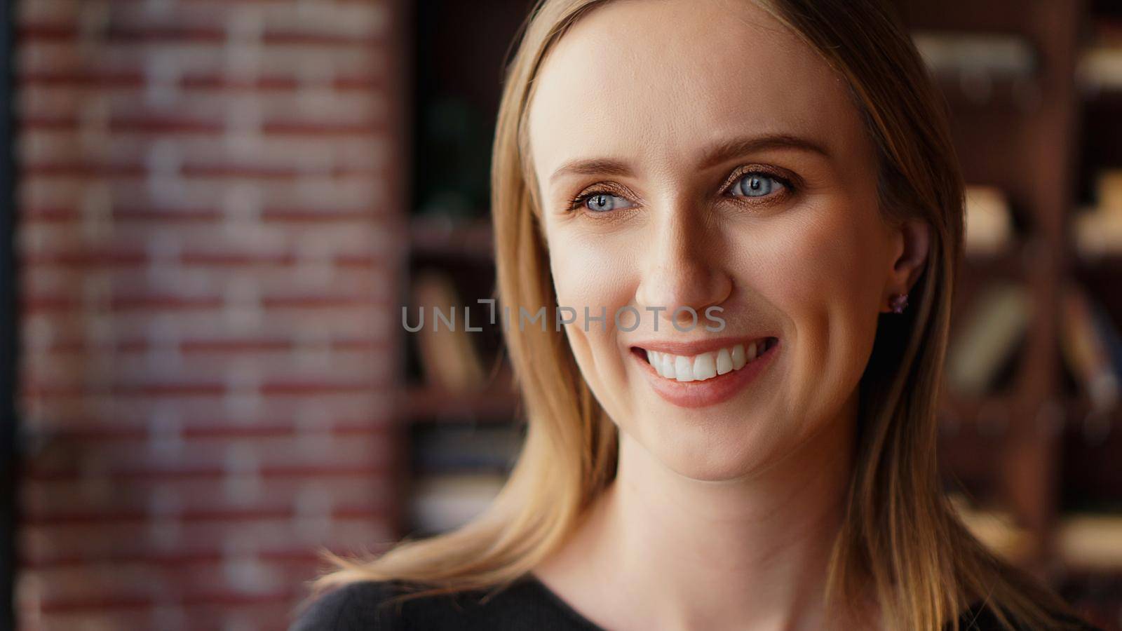 Happy woman in loft office background. Successful and happiness concept. Portrait of young cheerful woman