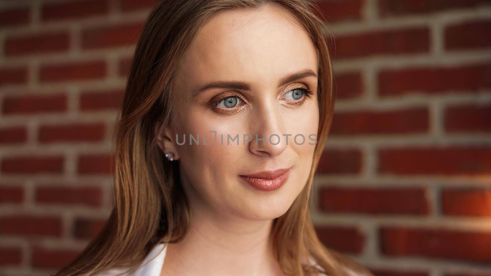 Close up Happy Young Woman Wearing Casual white shirt In Front red Brick Wall - Loft interior