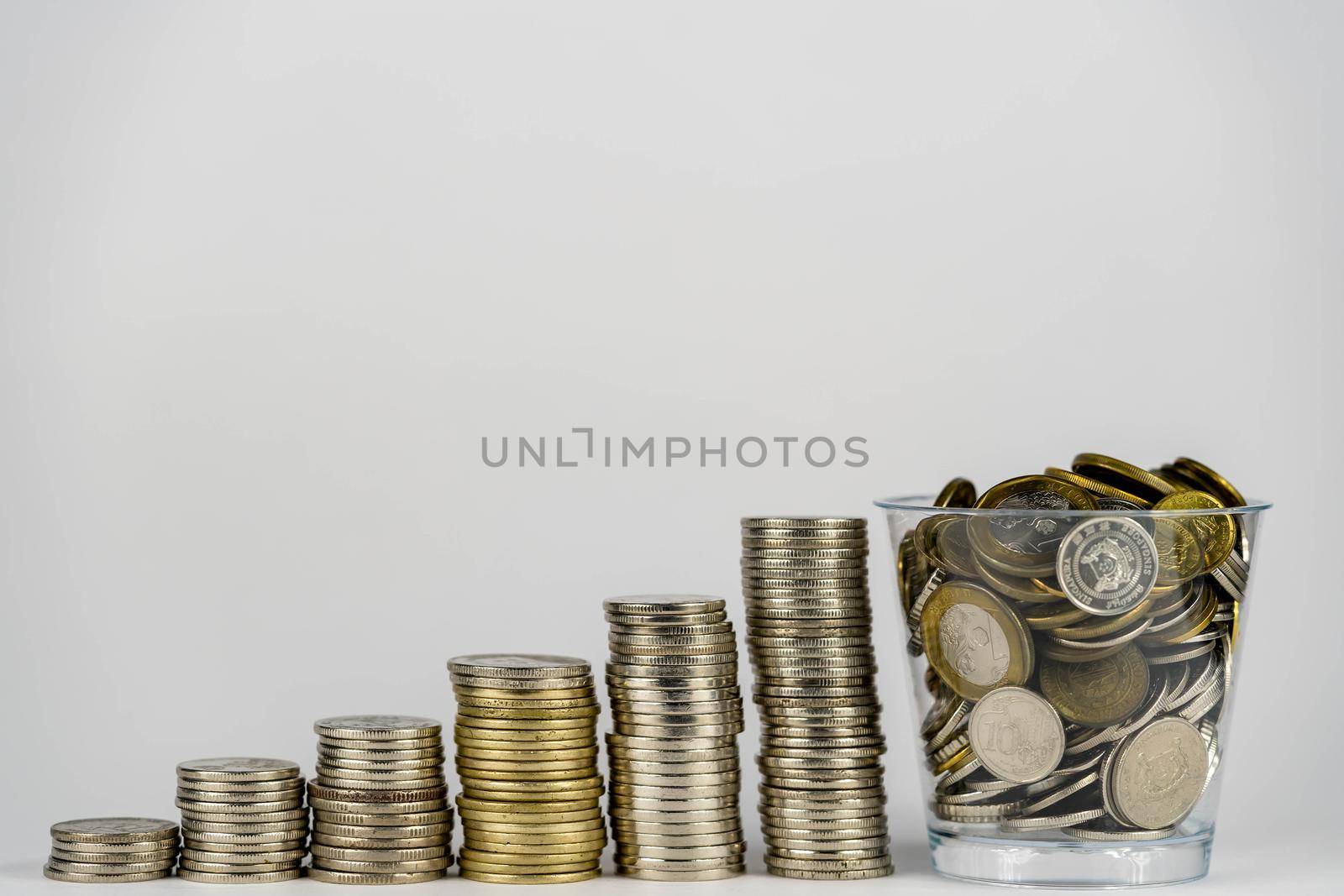 money saving, business financial growth, economy budget and investment concept. golden coins in jar and coin stack growth up on white background. by billroque