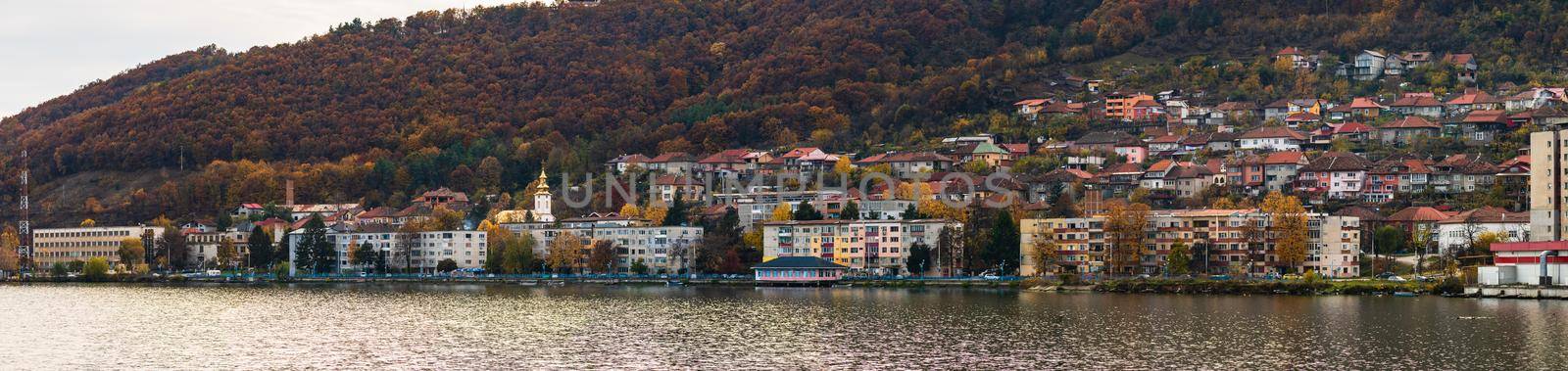 View of Danube river and Orsova city vegetation and buildings, waterfront view. Orsova, Romania, 2021 by vladispas