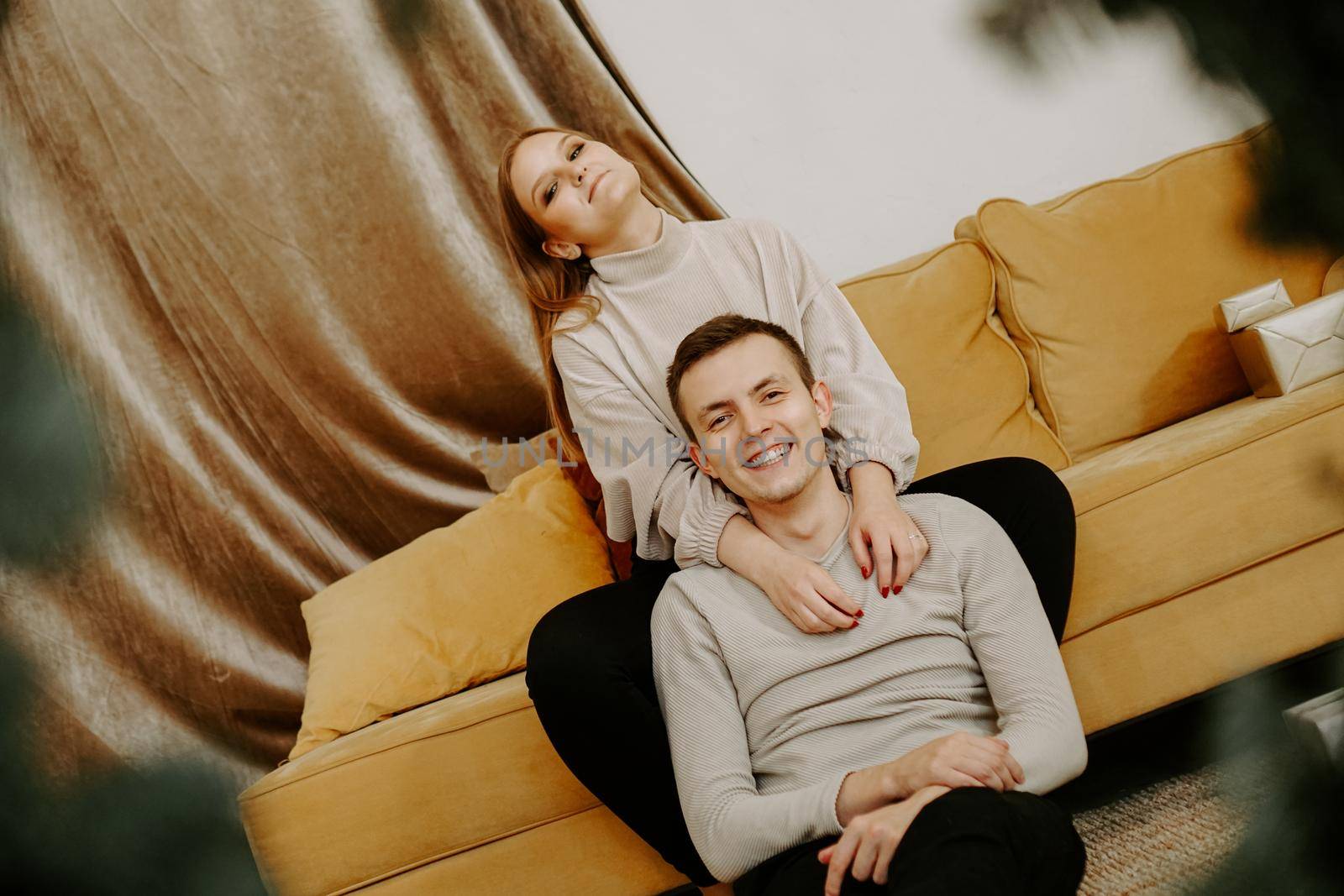 Couple relaxing together on the couch. Happy young couple by natali_brill