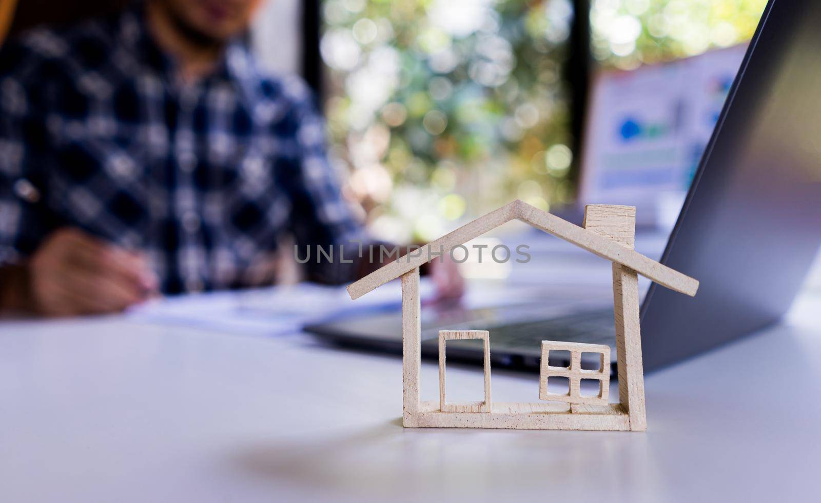 Model House with background businessman working about housing, property, loan house.