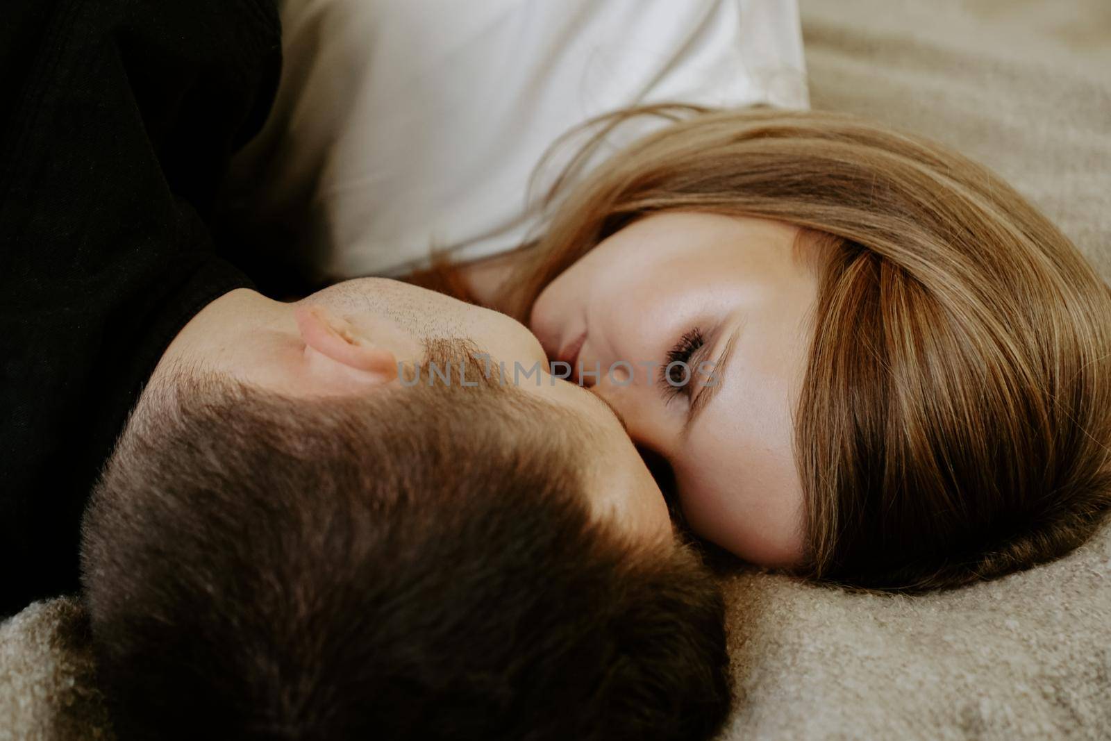 Close-up portrait of a young couple in bed at home by natali_brill