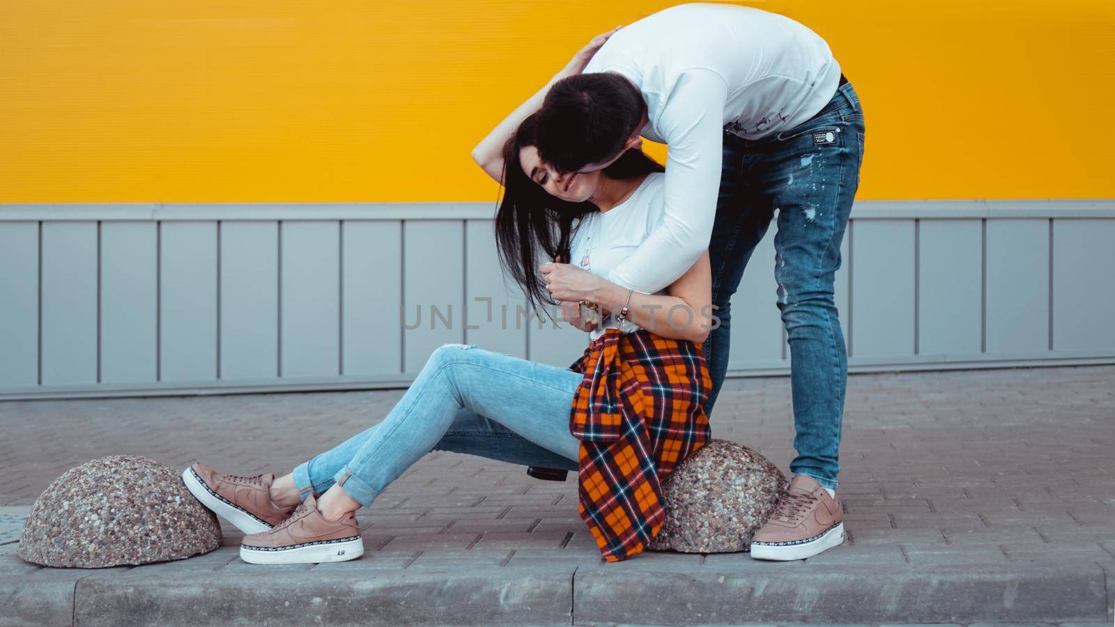 Image of Young lovely couple posing together and hugging over yellow background