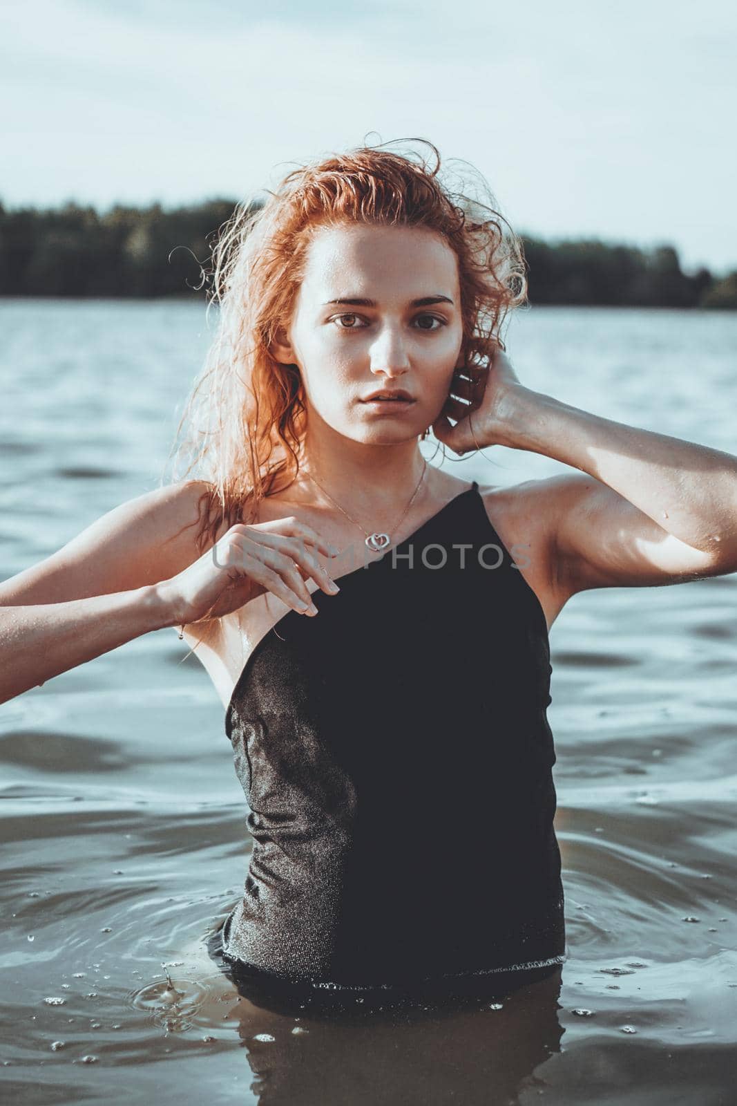 Young beautiful woman standing in the water. by natali_brill