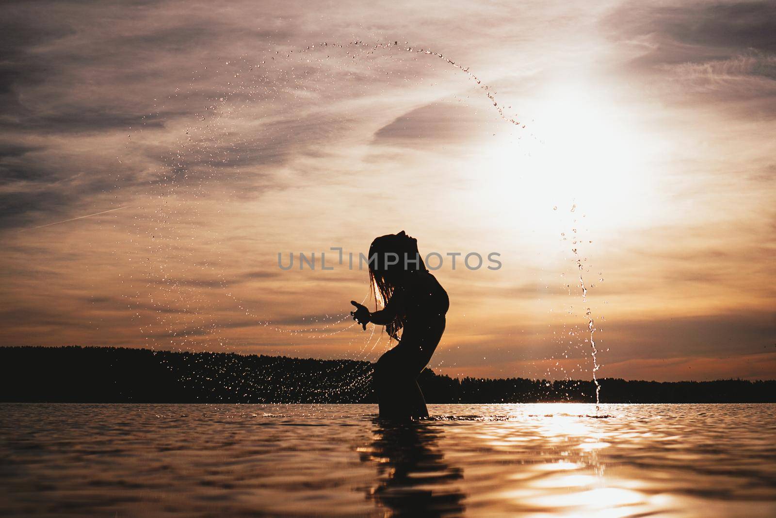 Beauty Model Girl Splashing Water with her Hair. Woman in Water. by natali_brill