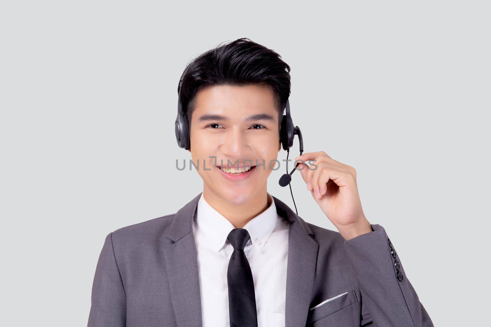 Portrait young asian business man call center wearing headset isolated on white background, agent with support and service, businessman is assistant for client with phone or helpline online.