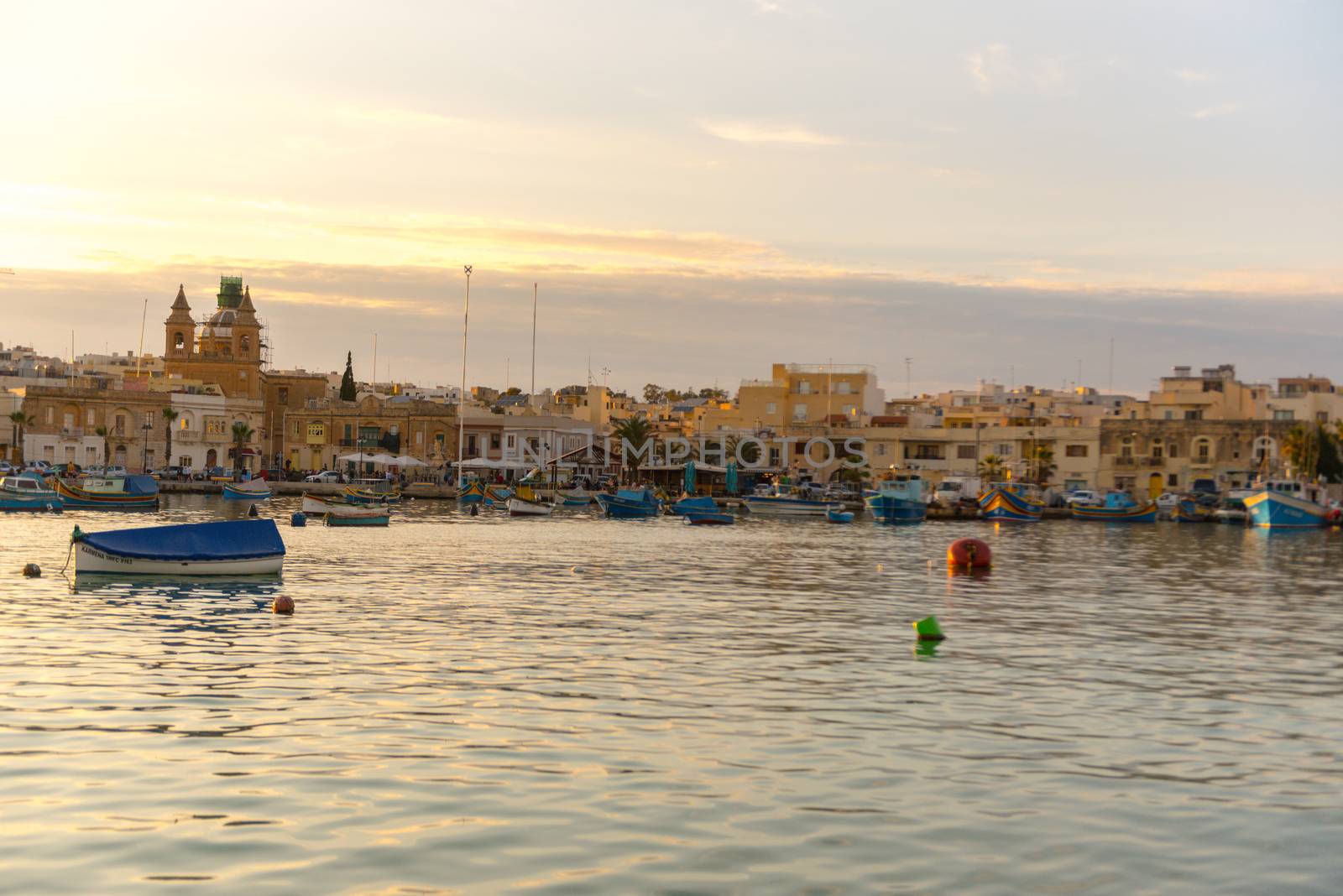 Traditional eyed colorful boats Luzzu in the Harbor of Mediterranean fishing village Marsaxlokk, Malta