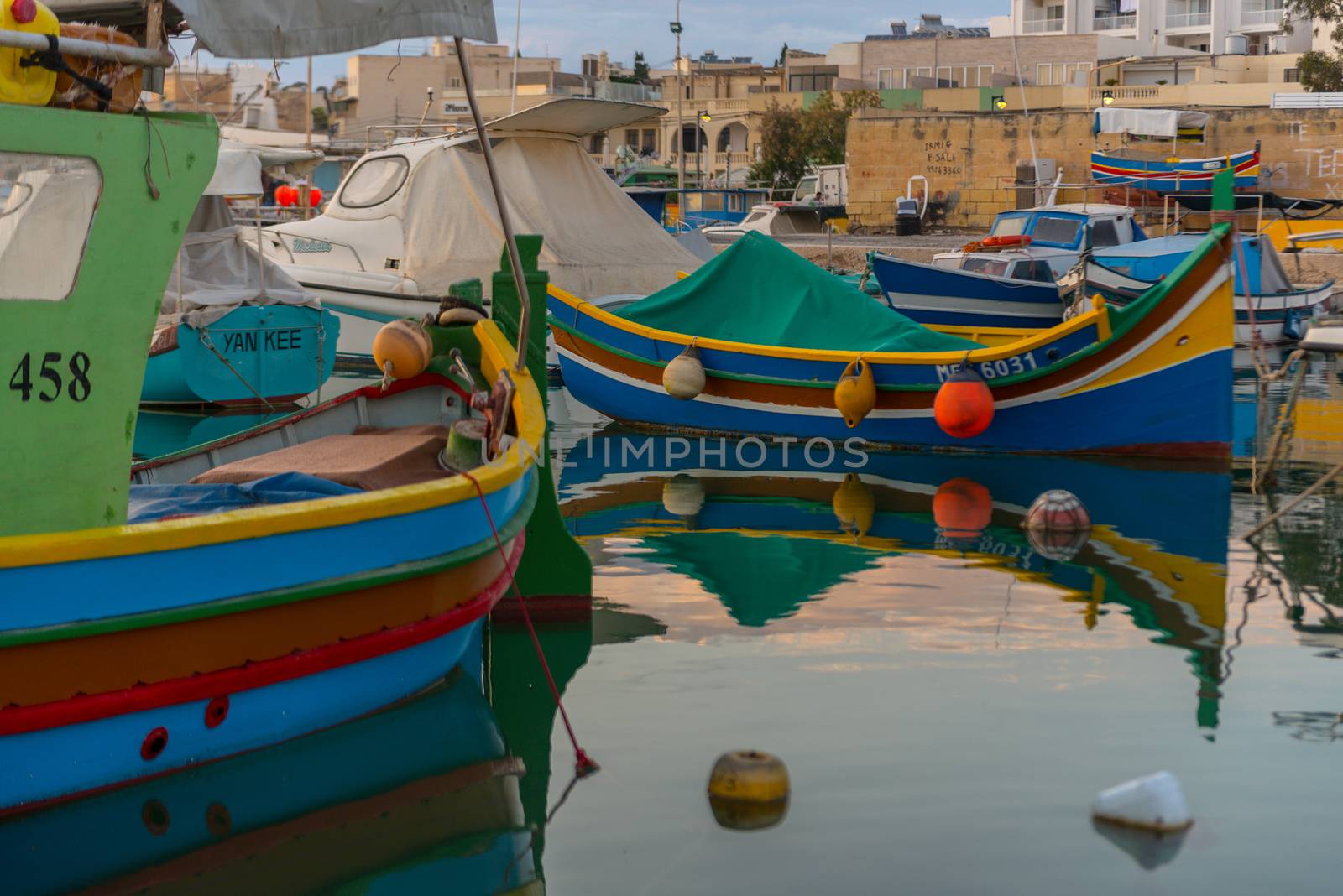 Traditional eyed colorful boats Luzzu in the Harbor of Mediterranean fishing village Marsaxlokk, Malta