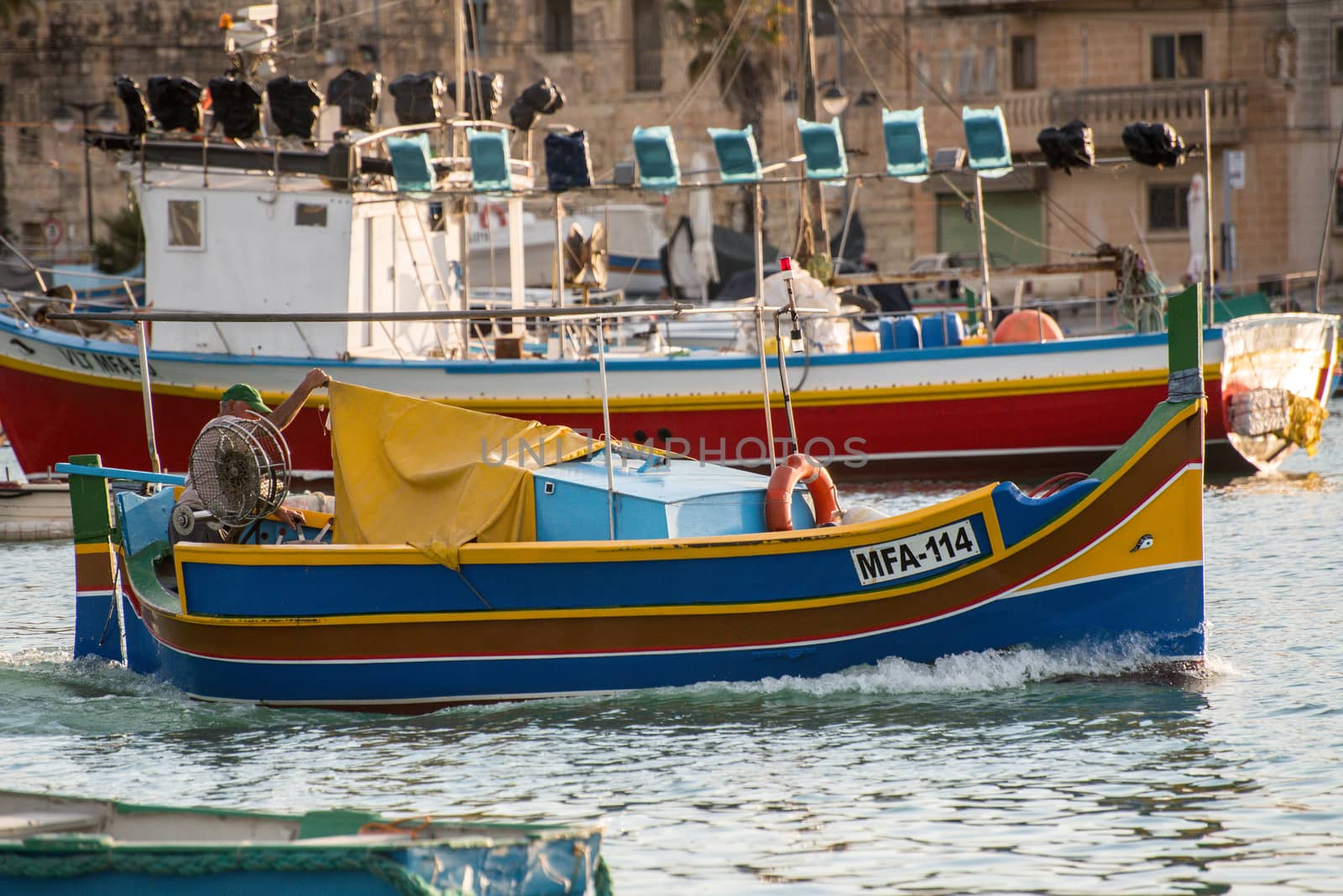 People are enjoying sunny day at Saint Peter's pool near Marsaxlokk, Malta