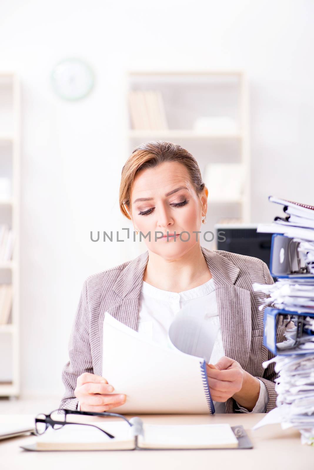 Businesswoman very busy with ongoing paperwork