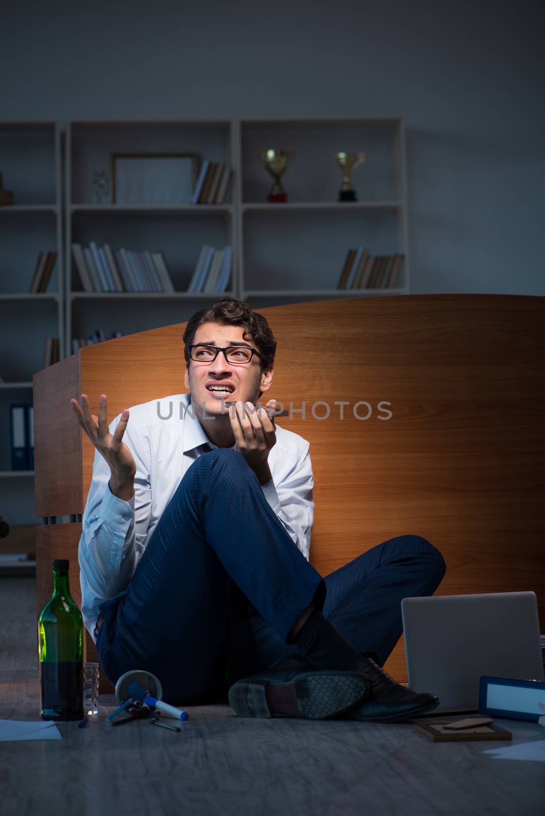 Stressed businessman working overtime in depression