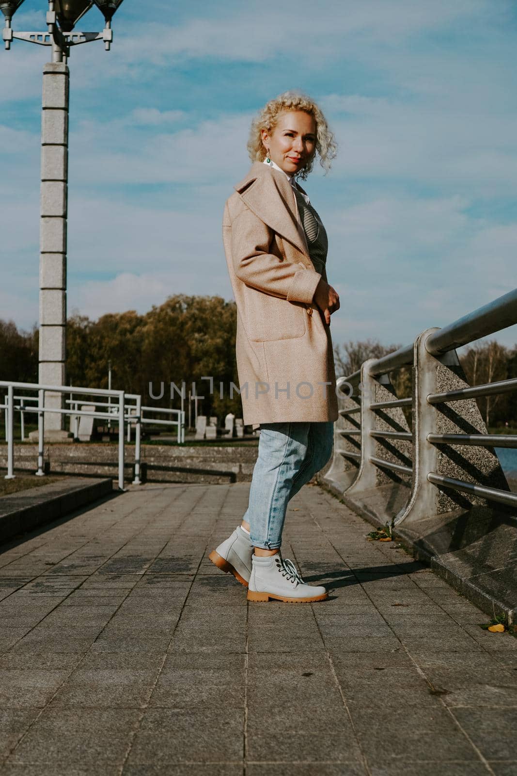 Stylish Pretty Young Woman in Autumn Fashion walking in the city