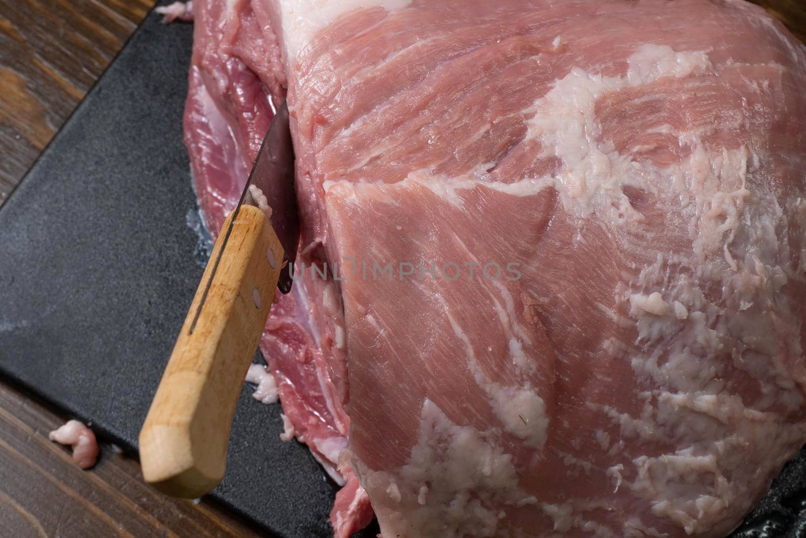 Slice the pork or beef with a knife on the table in close-up.Preparation of meat dishes and food products.Pieces of red meat for shish kebab,barbecue or kebab.Raw fresh meat is cut with a knife.recipe by YevgeniySam