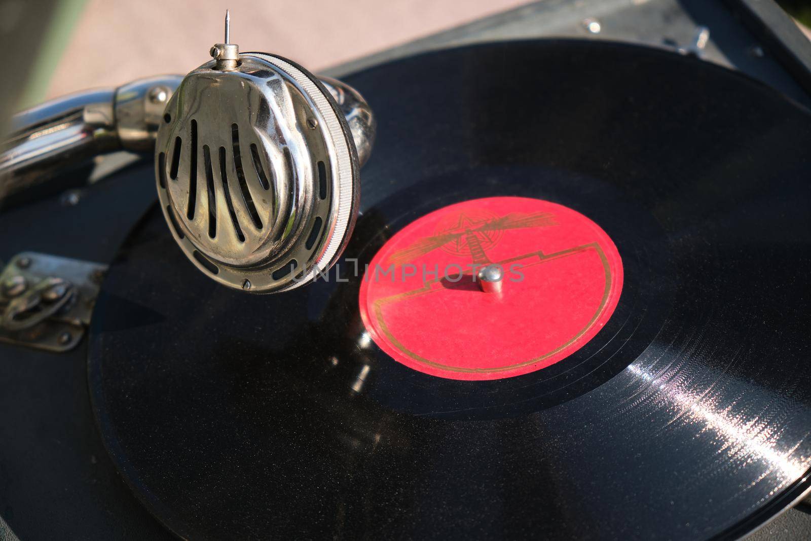 Detail of an old gramophone playing an original vinyl record.