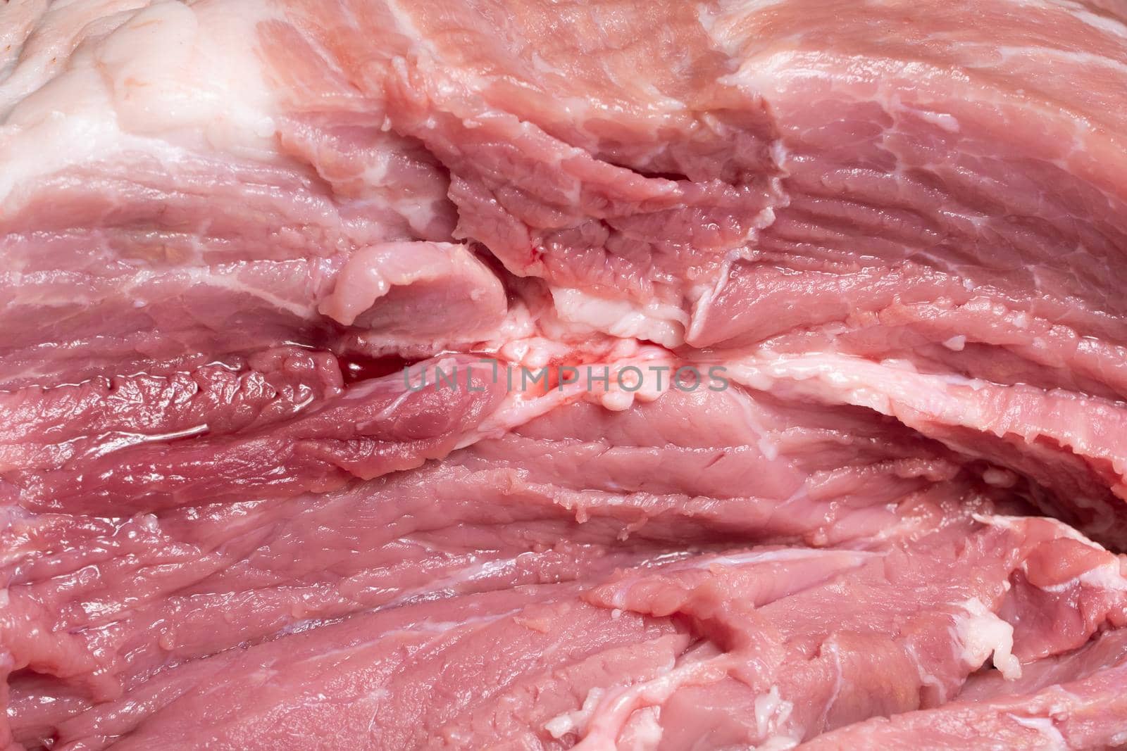 Slice the pork or beef with a knife on the table in close-up.Preparation of meat dishes and food products.Pieces of red meat for shish kebab,barbecue or kebab.Raw fresh meat.recipe by YevgeniySam