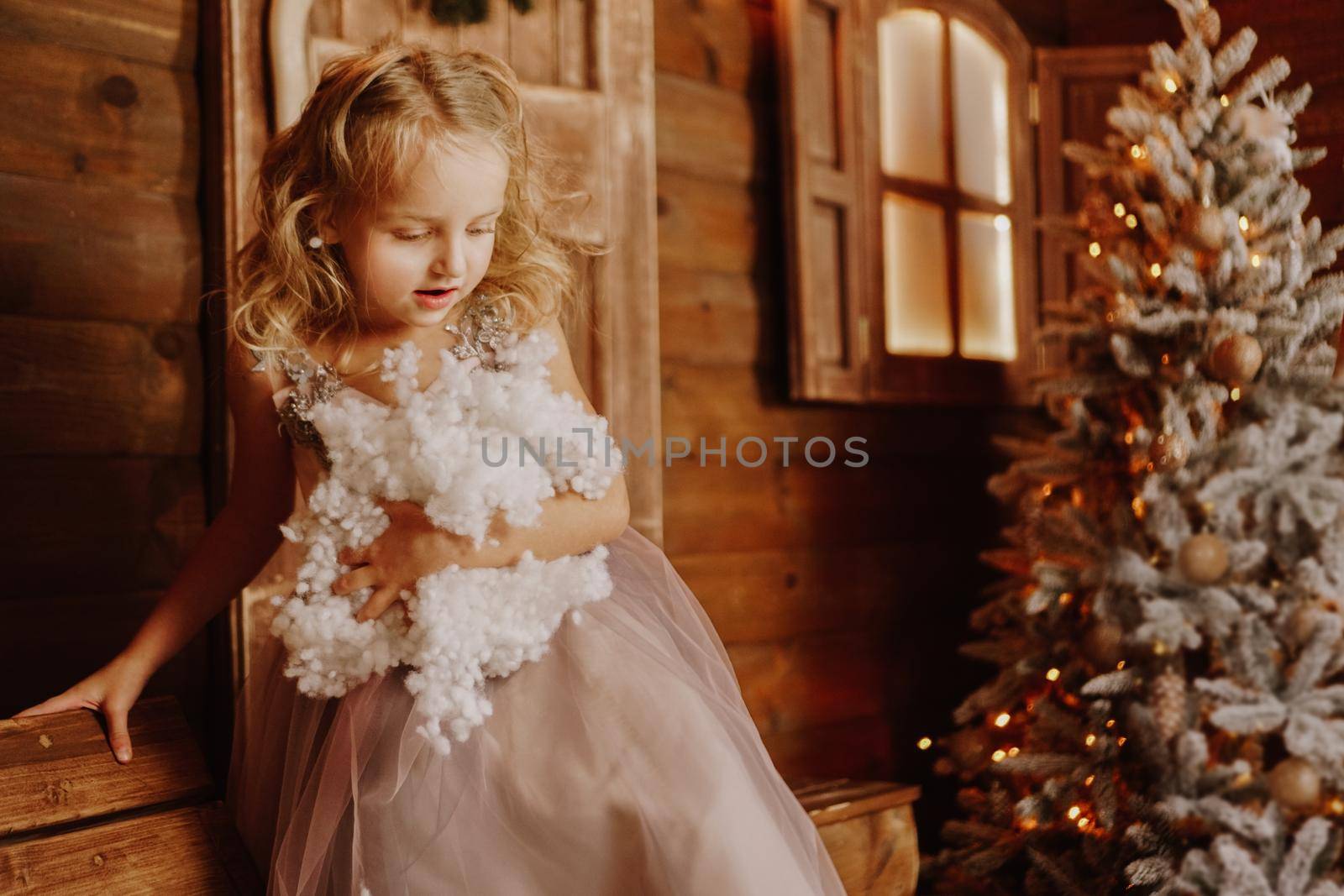 Little girl in pink dress is holding fake snow by natali_brill