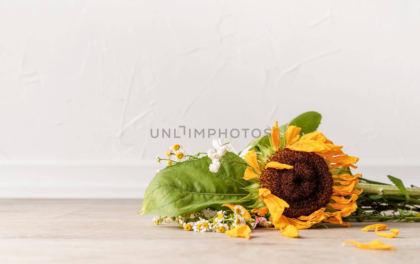 A bouquet of withered flowers on the floor by Desperada