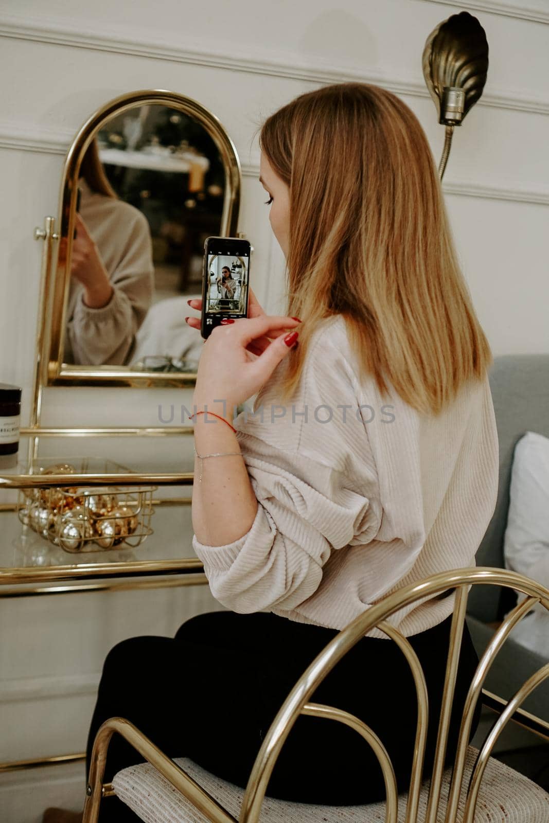 Beautiful woman makes selfie in room near her dressing table by natali_brill