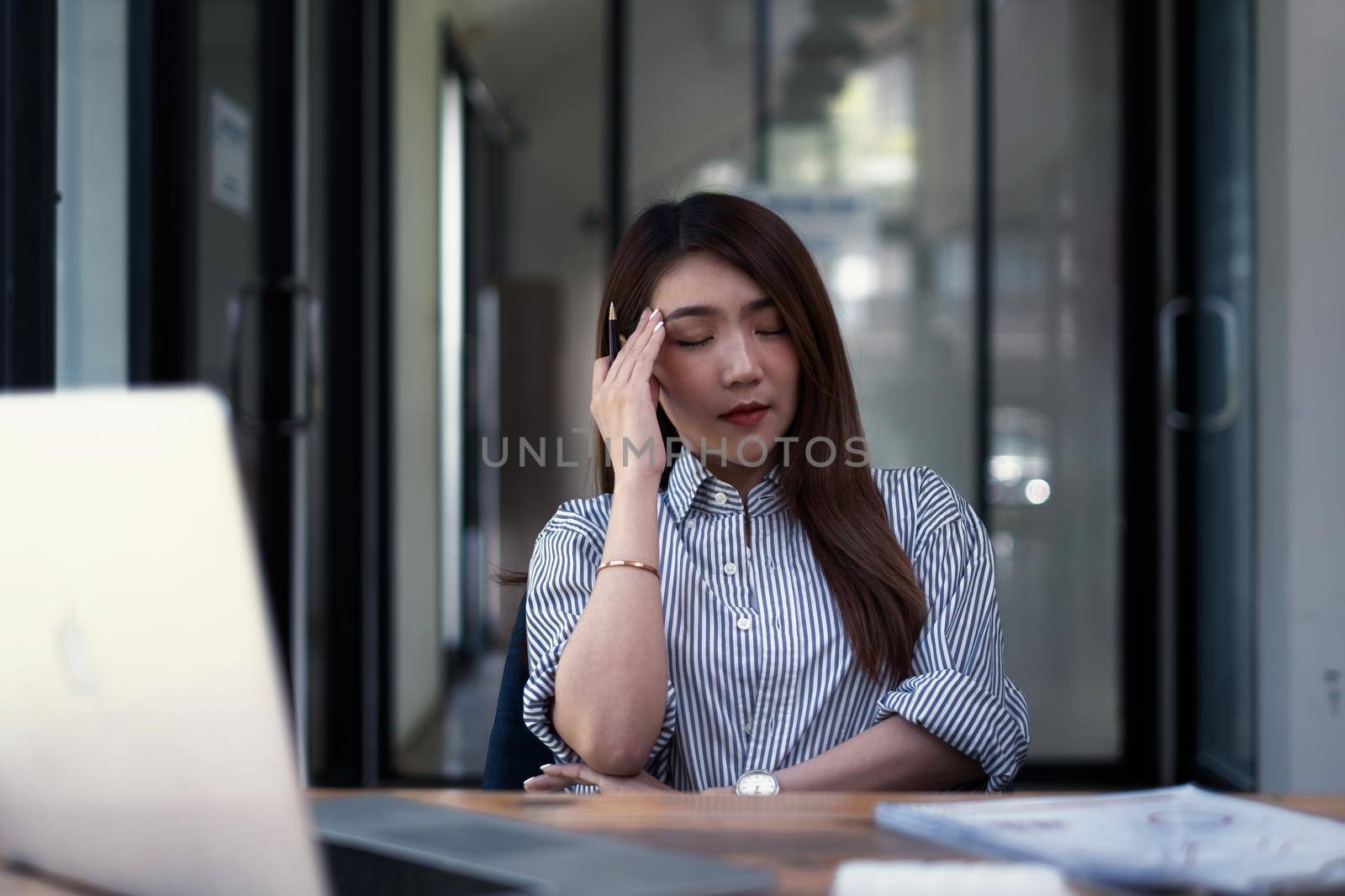 Frustrated stressed business owner or accountant sitting in an office because covid-19 has disappoint. Close business cafe shop concept. by itchaznong
