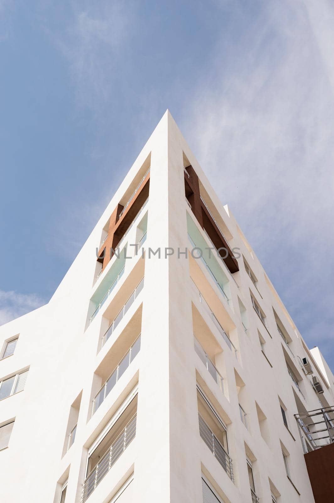 Modern hotel or apartment building on sky background. Symmetry