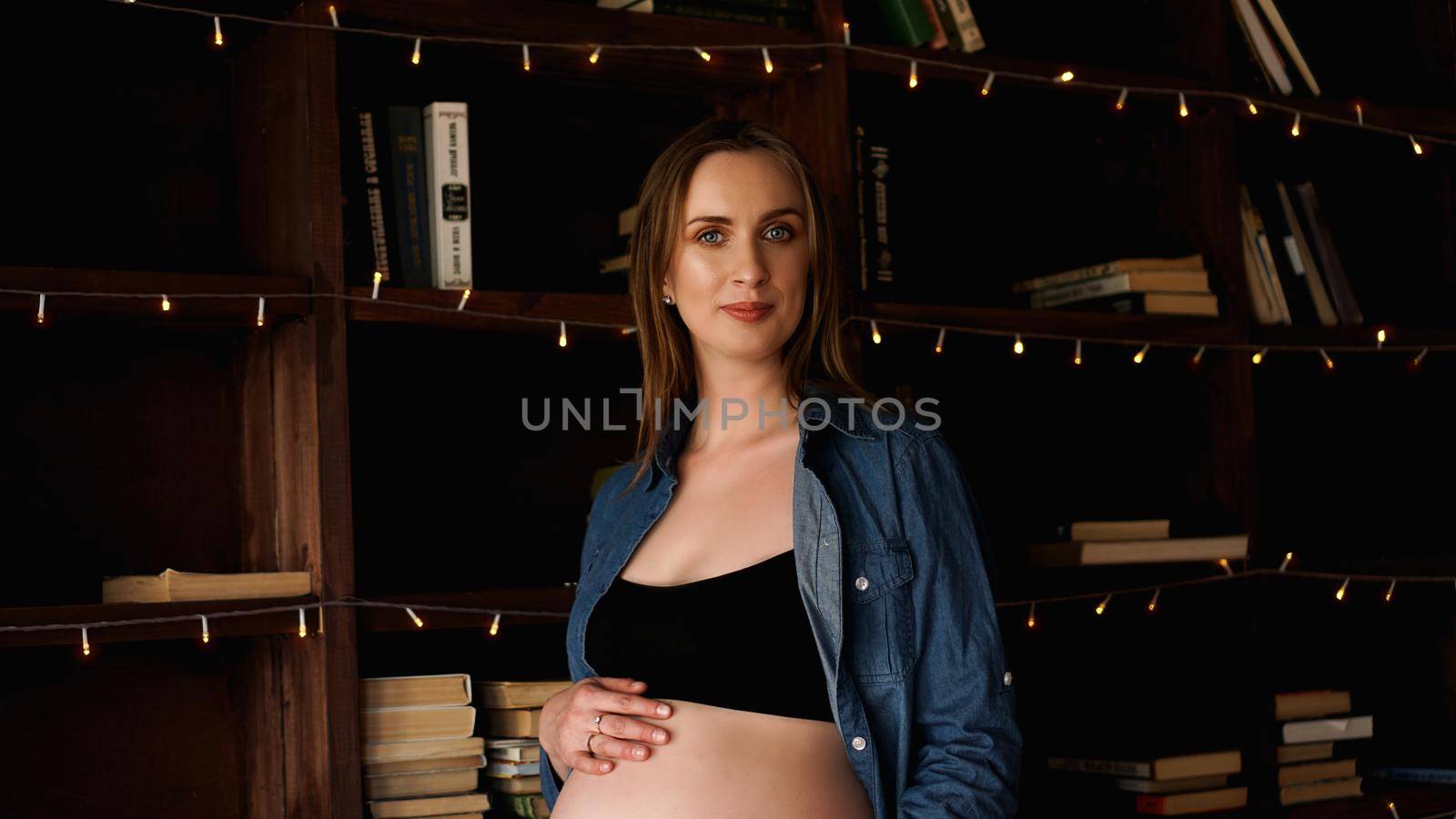 Beautiful young stylish pregnant woman, in black lingerie and blue shirt, loft by natali_brill