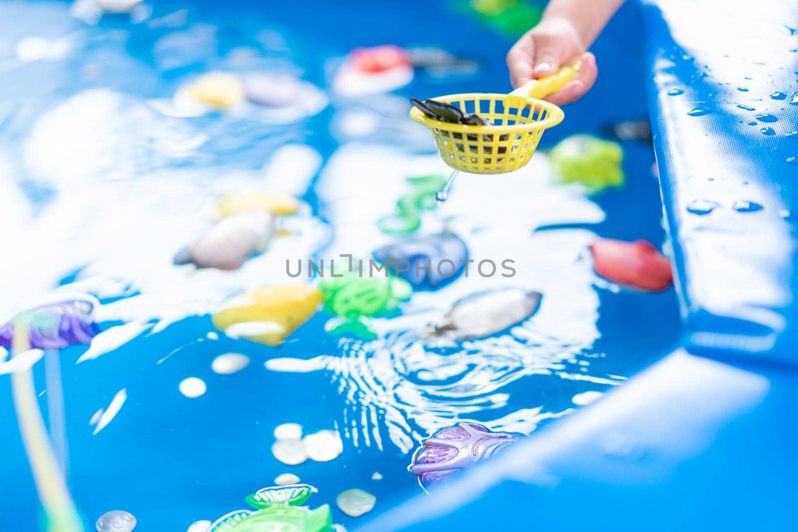 Child Fisher Catching Plastic Toy Fish On Pool Amusement Park Summer Day Little Girl Have Fun On Fishing Carnival Festival Entertainment For Children